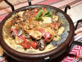 Sach /flat earthen baking dish/ on metal stand
